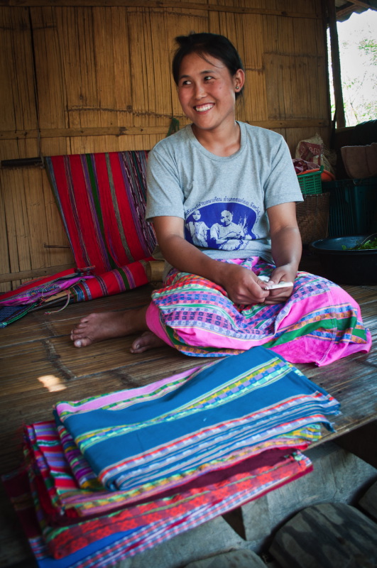 Pwo Karen artisan shows her handwoven sarongs